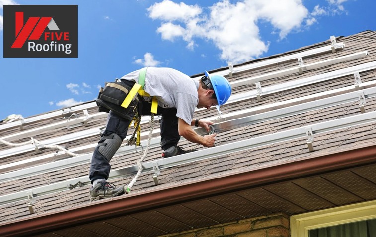 Worker repairing roof flashing to improve roof durability