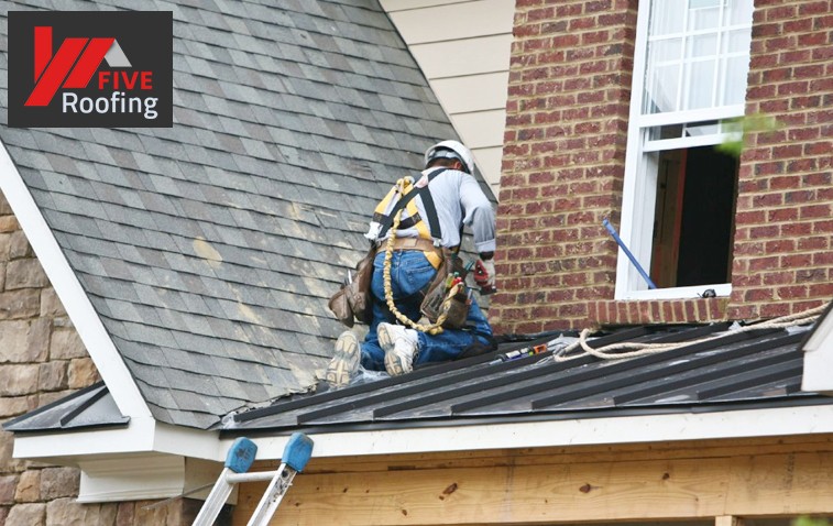 Worker installing roof vents to improve attic ventilation and prevent rot